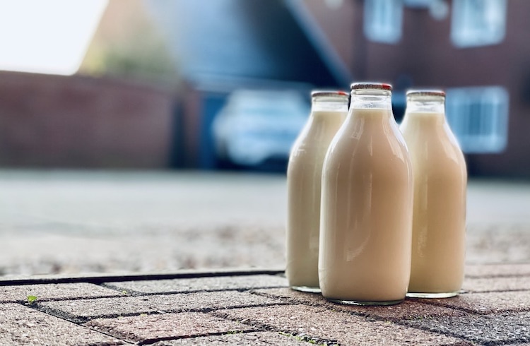 three glass bottles of milk