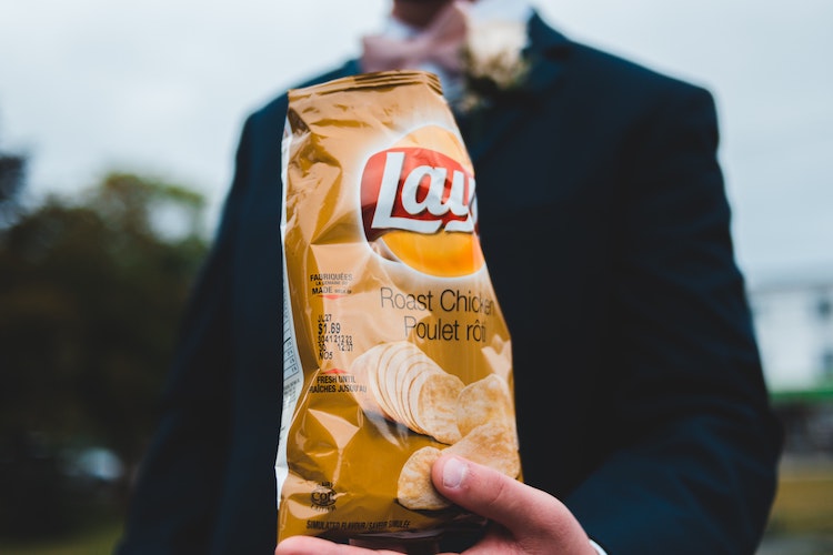 man holding potato chip bag