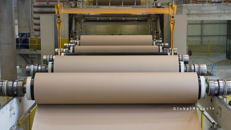 roll of brown paper being made into cardboard boxes